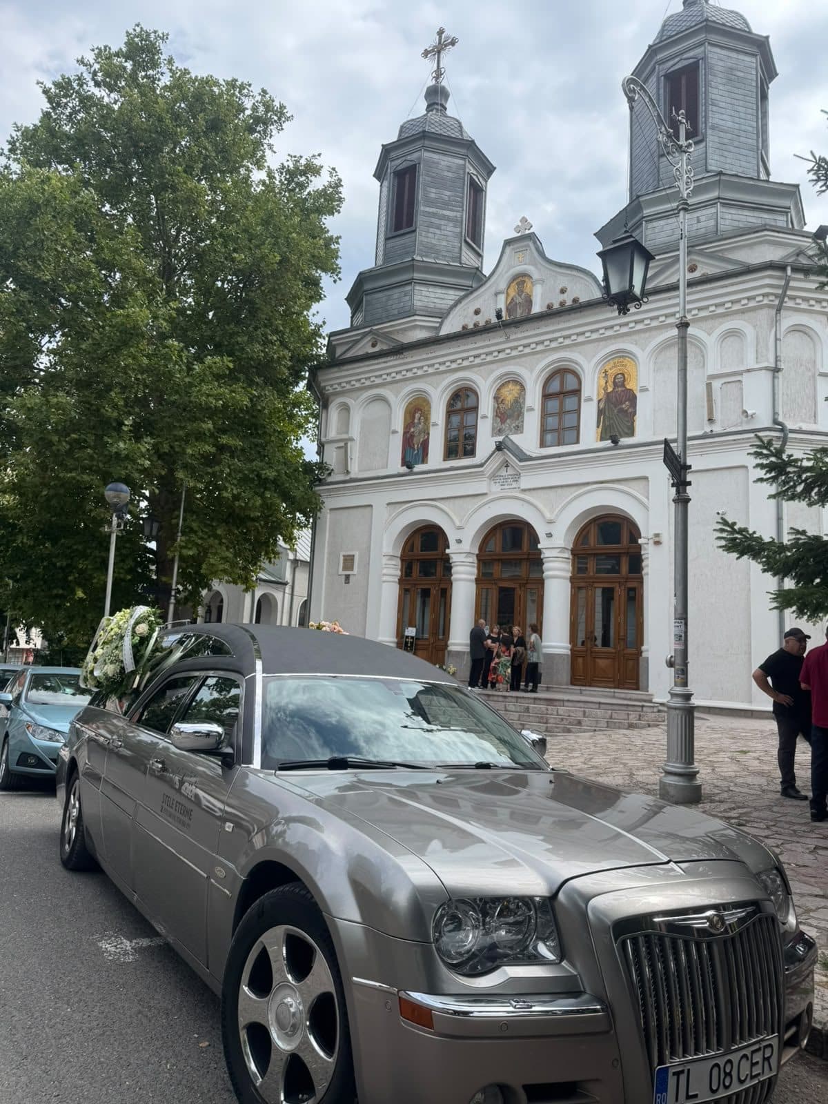Autospeciala funerară Stele Eterne în fața unei biserici din Tulcea