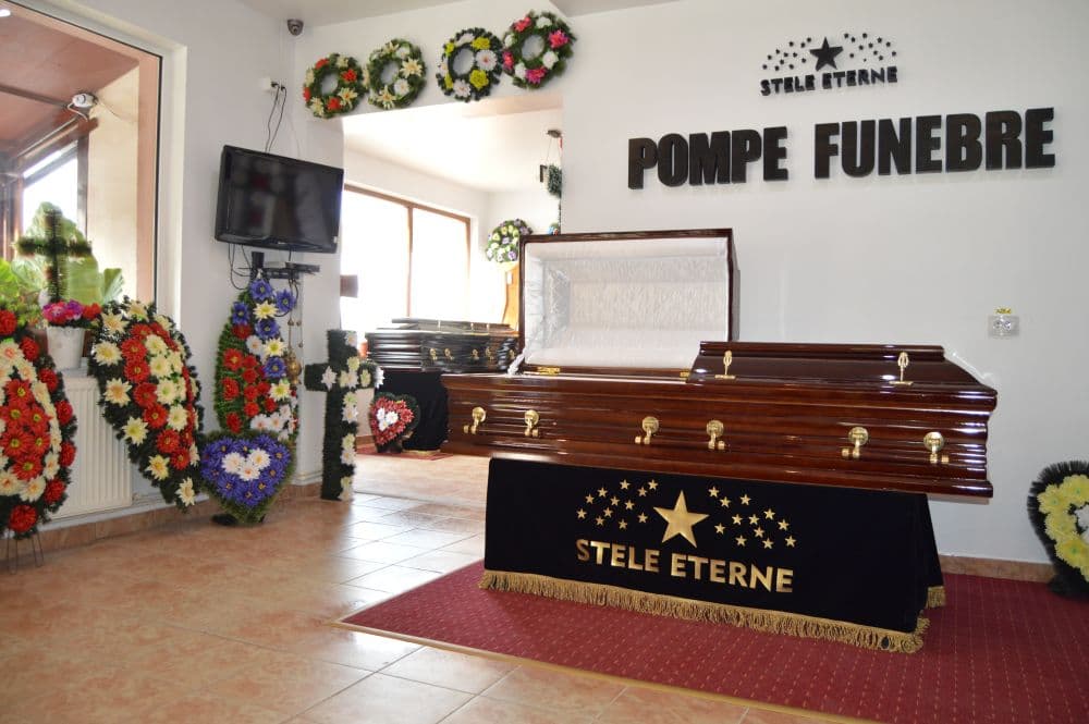 Sala de expunere Stele Eterne Tulcea, cu sicriu și coroane